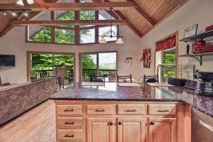 a kitchen with wooden cabinets and a large window at Charming 4BR Cabin - HOT TUB - Mountain View in Hoyes Run
