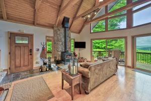 a living room with a couch and a fireplace at Charming 4BR Cabin - HOT TUB - Mountain View in Hoyes Run