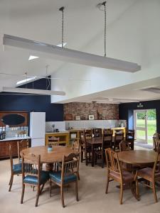 a dining room with wooden tables and chairs at Kindrogan House in Straloch