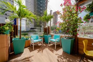 a row of chairs and potted plants on a balcony at POUSADA BEIRA MAR in Fortaleza