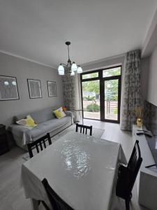 a living room with a table and a couch at Baytur Resort таунхаус in Bosteri