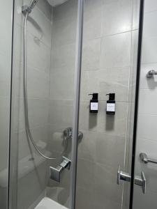 a bathroom with a shower with a glass door at A&R Santiago de Compostela in San Sebastián de los Reyes +47 photos