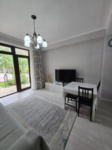 a living room with a table and a dining room at Baytur Resort таунхаус in Bosteri