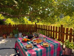 a picnic table with food on it with a fence at RVilla in Pavliani