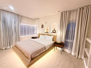 a bedroom with a bed and a large window at CASA MARINe in Bophut