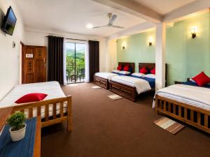 a hotel room with two beds and a window at Kithaya Ella in Ella