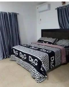 a bedroom with two beds with a big dog blanket at Naira & Kobo Hotel and suite in Umuahia
