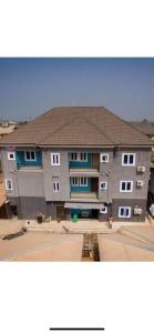 a large building with a brown roof at Naira & Kobo Hotel and suite in Umuahia