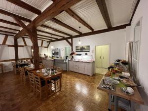 a large kitchen with wooden floors and wooden ceilings at Pension Maintal Eltmann in Eltmann