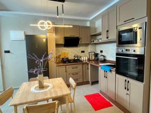 a kitchen with a table and a dining room at appartemment essaouira in Essaouira