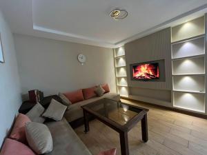 a living room with a couch and a fireplace at appartemment essaouira in Essaouira