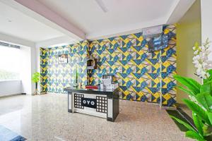 a room with a colorful tile wall and a table at Hotel O Gulabi Delight in Faridabad