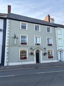 a white building on the side of a street at The Beacons Guest House in Brecon