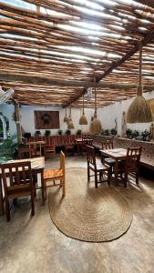 a dining room with tables and chairs in a room at Kilimanjaro in Nungwi