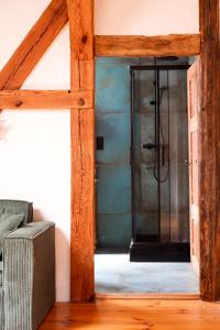 a bathroom with a glass shower in a room at Wronki- mazurski spokój in Wronki