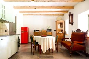 a kitchen with a table and chairs and a red refrigerator at Wronki- mazurski spokój in Wronki