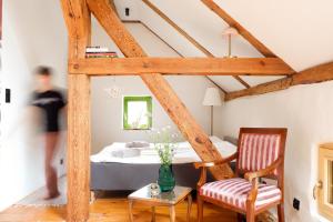 a room with a bed and a table and a chair at Wronki- mazurski spokój in Wronki +39 photos