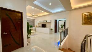 a hallway with a door and a living room at Ramz Residence in El Nido