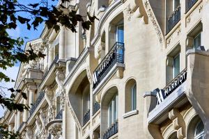 a building with balconies on the side of it at Paris Marriott Champs Elysees Hotel in Paris +144 photos