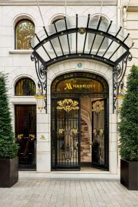 a store front of a marriott building with a gate at Paris Marriott Champs Elysees Hotel in Paris