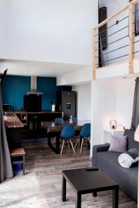 a living room with a couch and a table at Les Tiny d'Aureilhan avec Jacuzzi privatif in Aureilhan