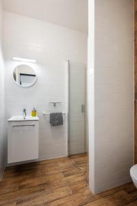 a white bathroom with a sink and a shower at Bohem Prague Hotel in Prague