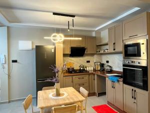 a kitchen with a table and a dining room at appartemment essaouira in Essaouira +7 photos