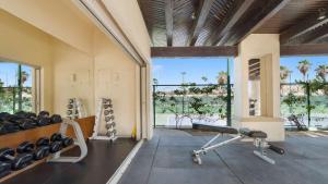 an empty gym with a bench and a large window at Las Mañanitas LM C208 in San José del Cabo
