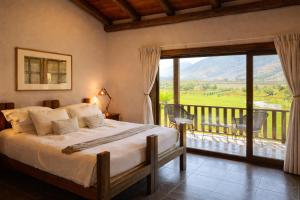 a bedroom with a bed and a balcony with a view at Hotel Casa De Campo in Santa Cruz +66 photos