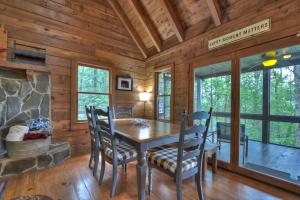 a dining room with a table and chairs at Oscars Outpost Fire Pit Pet Friendly in Mineral Bluff