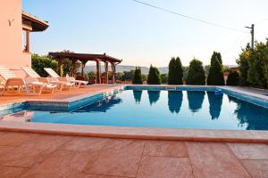 a swimming pool with chairs and a gazebo at Holiday Home Senko in Blagaj +62 photos