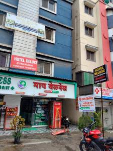 a building with signs on the side of it at Hotel Deluxe in Hinjewadi