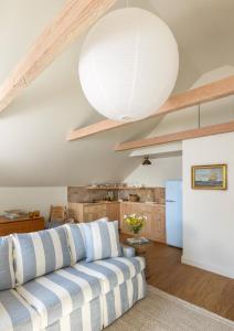 a living room with a couch and a large light fixture at The Lightkeeper’s Inn in Edgartown