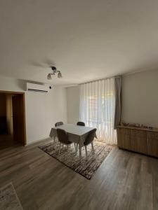 a white room with a table and chairs in it at Dielli's house in Gnjilane +2 photos