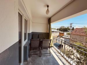 a balcony with chairs and a table on a balcony at Dielli's house in Gnjilane