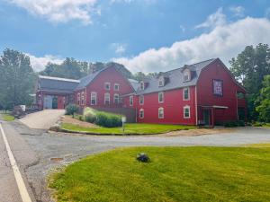 a large red building on the side of a road at The Barn Inn Bed and Breakfast in Millersburg