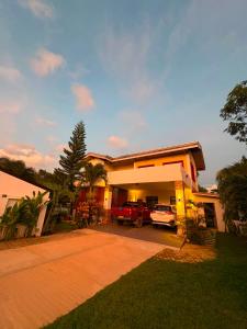 a house with a red car parked in front of it at Ramz Residence in El Nido