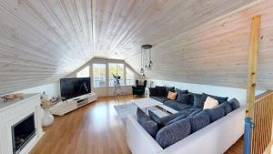 a living room with a couch and a tv at Villa Seeblick in Vissefjärda
