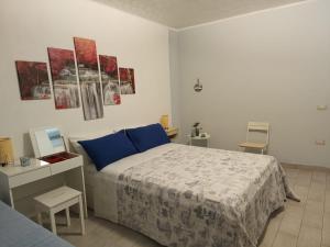 a bedroom with a large bed with blue pillows at Il sentiero delle fate in Caserta +33 photos