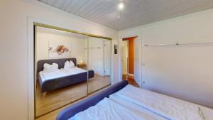 a bedroom with a bed and a large mirror at Villa Waldsee in Vissefjärda +81 photos