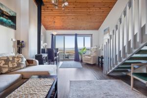 a living room with a couch and a table at Shorewater Resort, Qualicum Beach in Qualicum Beach