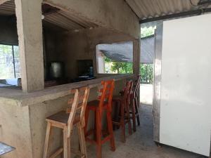 a group of chairs sitting at a bar at Casa campo Villa Yaneth in Pueblo Bello