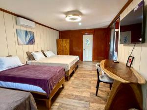 a hotel room with two beds and a table at Kokoro Garden in Fortuna +63 photos