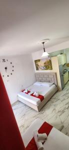 a bedroom with a bed in a room with birds on the wall at Koci Apartments in Sarandë
