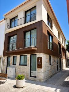 a building with a balcony on top of it at Terra Clara Studios & Apartments in Esposende