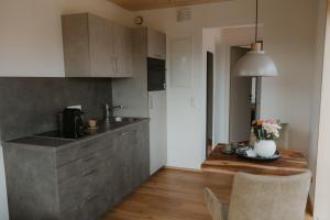 a kitchen with a sink and a wooden table at Natururlaub by Klotz TINY HAUS b in Überlingen