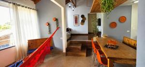 a dining room with a wooden table and orange chairs at Bem-estar e boa localização (Apto Paraíso) in Maringá