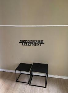 a table in a room with a sign on the wall at Adam's Sonnenberg Apartment in Chemnitz