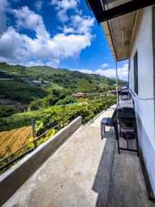 a balcony with a view of the mountains at Triple A Kundasang in Ranau