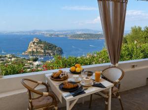 a table with food and a view of the ocean at Barracuda Suite Sea View & Dinner Experience in Ischia Town